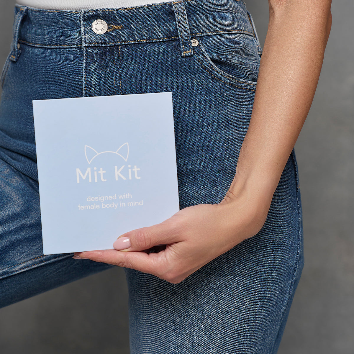 Woman holding Mit Kit intimate hygiene kit packaging designed for feminine care