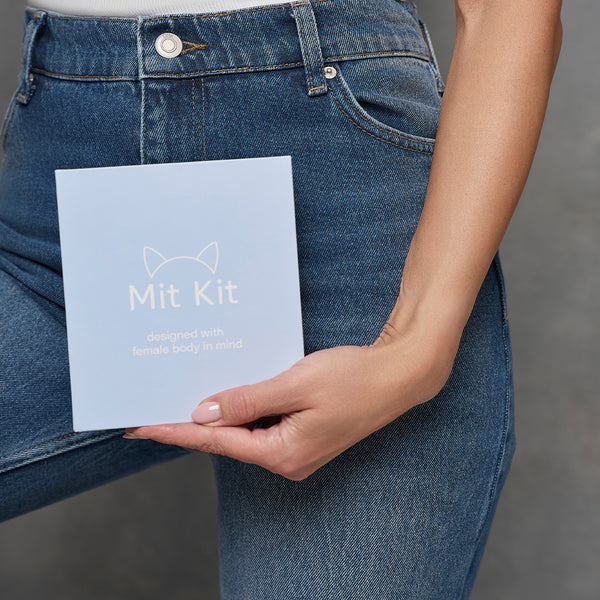 Woman holding Mit Kit intimate hygiene kit packaging designed for feminine care